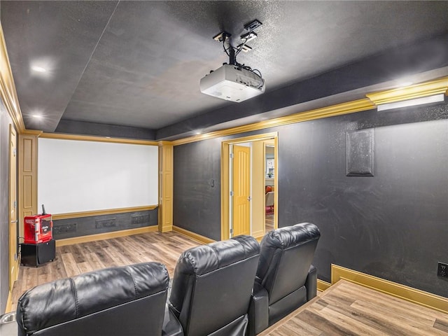 home theater with baseboards and wood finished floors