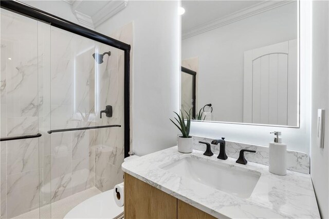 bathroom with toilet, a marble finish shower, vanity, and crown molding