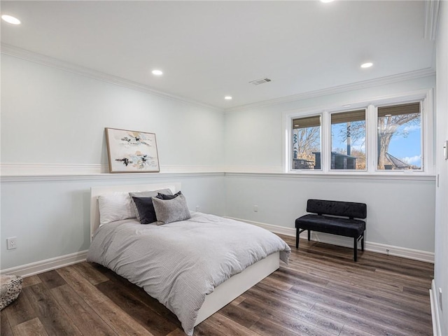 bedroom with recessed lighting, visible vents, ornamental molding, wood finished floors, and baseboards