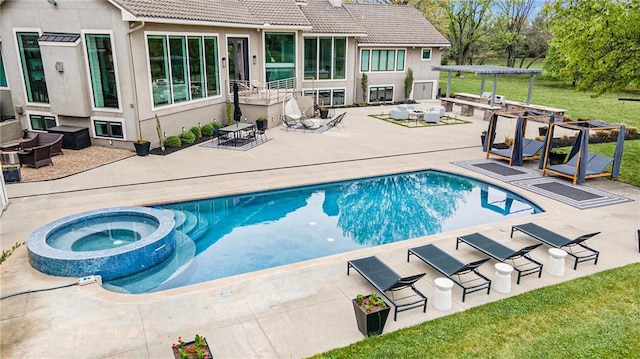 view of swimming pool with a pool with connected hot tub, a patio area, and a lawn