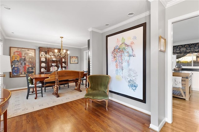 dining space with crown molding and light wood-style flooring