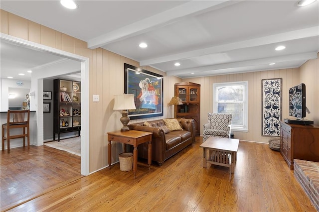 living area with beamed ceiling, recessed lighting, and wood finished floors