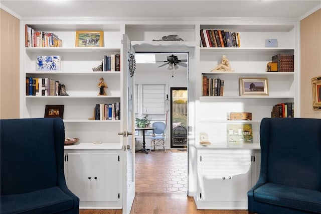 sitting room featuring built in features and ceiling fan