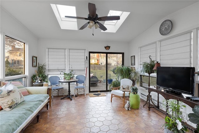 living room featuring lofted ceiling with skylight and a ceiling fan