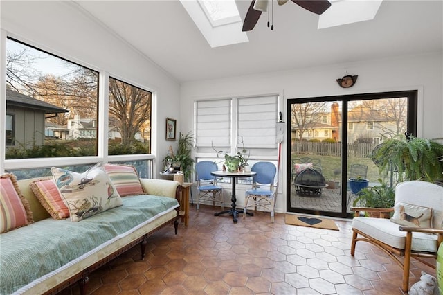 sunroom / solarium featuring a skylight and ceiling fan