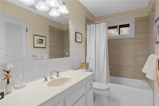 full bathroom featuring visible vents, tile walls, toilet, shower / bath combination with curtain, and vanity