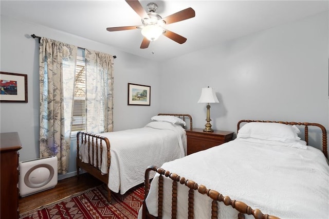 bedroom with a ceiling fan and wood finished floors