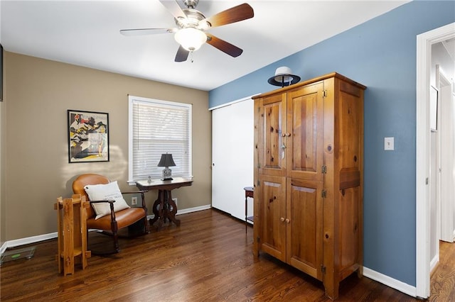 living area with dark wood-style floors, baseboards, and ceiling fan