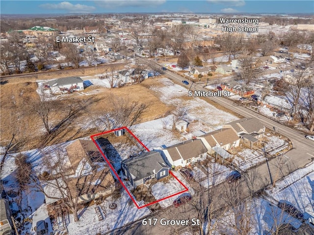 snowy aerial view with a residential view