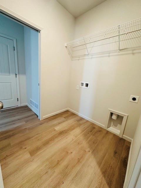 27115 E Oak View Dr, Lees Summit, MO 64086 - laundry room with hookup for a washing machine, hookup for an electric dryer, visible vents, baseboards, and light wood-type flooring