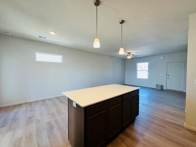 27115 E Oak View Dr, Lees Summit, MO 64086 - kitchen featuring a center island, pendant lighting, light countertops, open floor plan, and light wood-type flooring