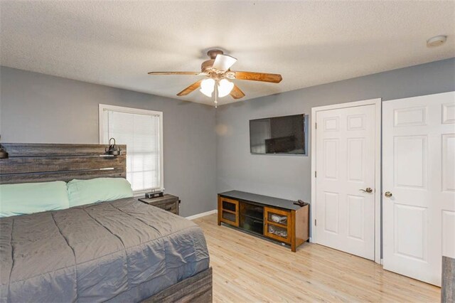 5990 Z Hwy, Edgerton, MO 64444 - bedroom with light wood-type flooring, a textured ceiling, a ceiling fan, and baseboards