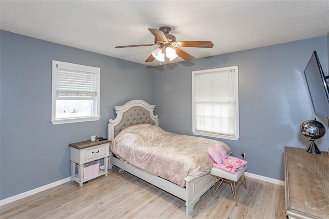 5990 Z Hwy, Edgerton, MO 64444 - bedroom with light wood-style floors, baseboards, ceiling fan, and a textured ceiling