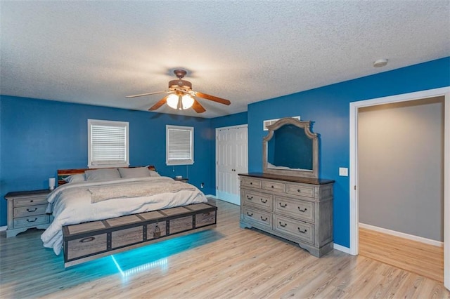 5990 Z Hwy, Edgerton, MO 64444 - bedroom featuring baseboards, wood finished floors, a textured ceiling, a closet, and ceiling fan