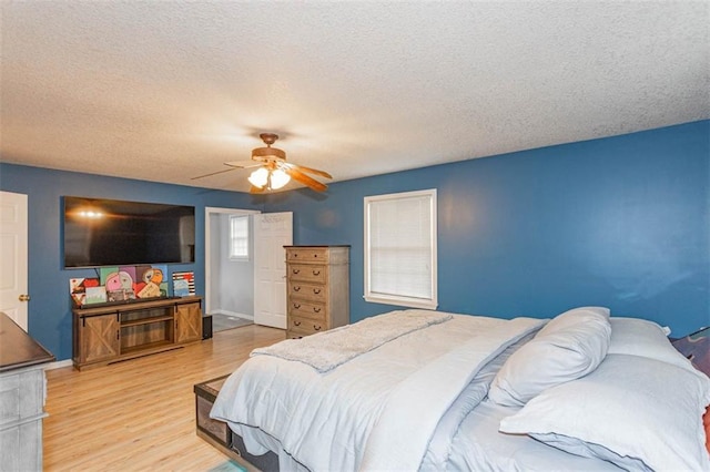 5990 Z Hwy, Edgerton, MO 64444 - bedroom with wood finished floors, a textured ceiling, and a ceiling fan