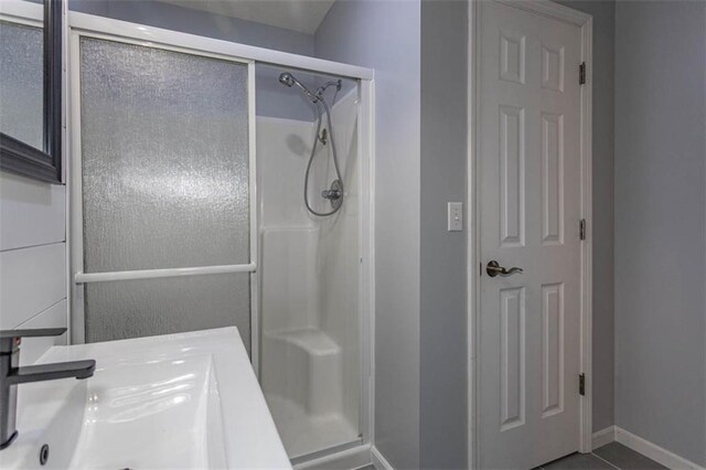 5990 Z Hwy, Edgerton, MO 64444 - full bath featuring a stall shower, baseboards, and a sink