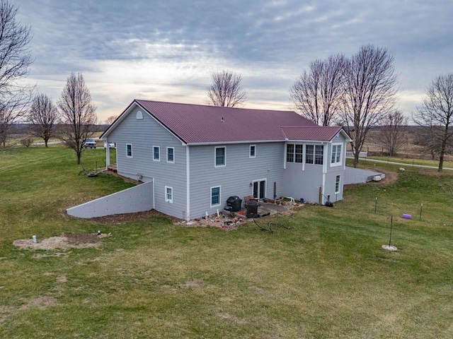 5990 Z Hwy, Edgerton, MO 64444 - rear view of property featuring metal roof and a yard
