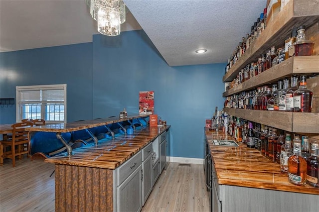5990 Z Hwy, Edgerton, MO 64444 - community bar area with light wood finished floors, baseboards, a textured ceiling, and a chandelier