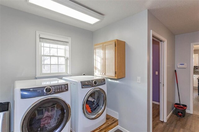 5990 Z Hwy, Edgerton, MO 64444 - washroom with cabinet space, washing machine and dryer, wood finished floors, and baseboards