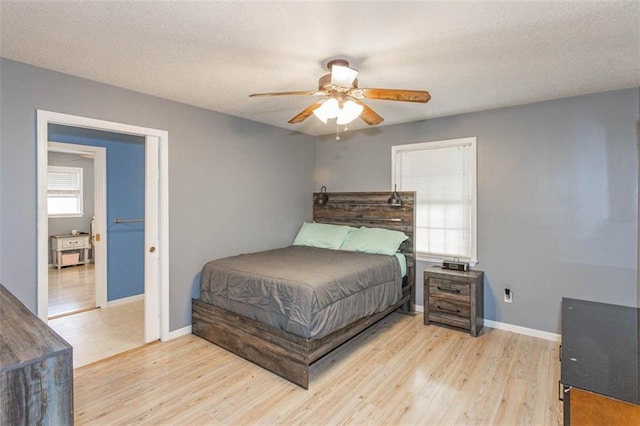 5990 Z Hwy, Edgerton, MO 64444 - bedroom with light wood-style flooring, baseboards, a textured ceiling, and ceiling fan