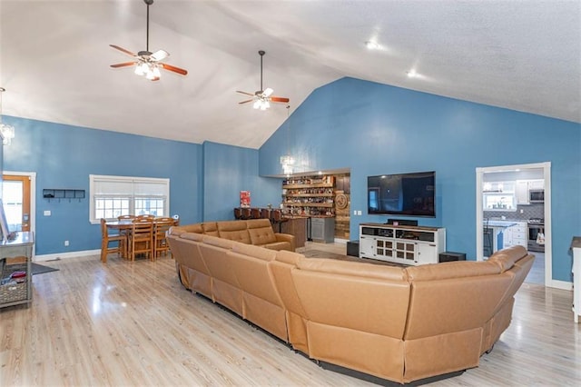 5990 Z Hwy, Edgerton, MO 64444 - living area with wood finished floors, high vaulted ceiling, a ceiling fan, and baseboards