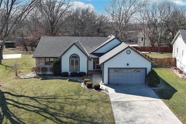 single story home featuring an attached garage, fence, driveway, roof with shingles, and a front yard