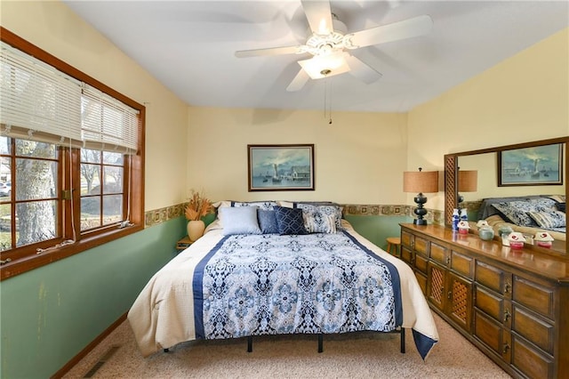 carpeted bedroom with visible vents and a ceiling fan