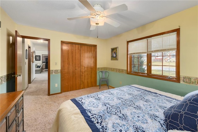 bedroom featuring ceiling fan, carpet floors, and a closet