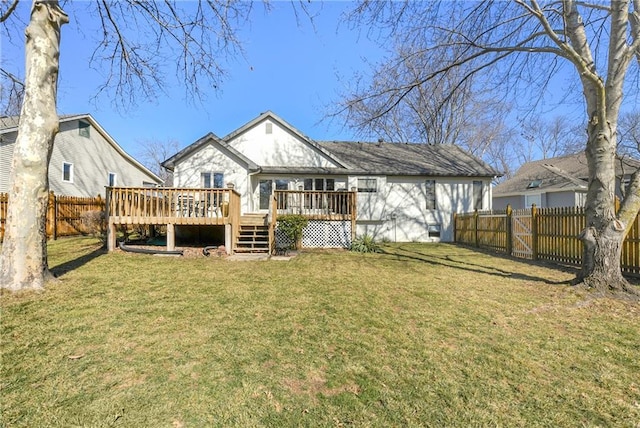 back of house featuring a gate, a fenced backyard, a yard, and a wooden deck