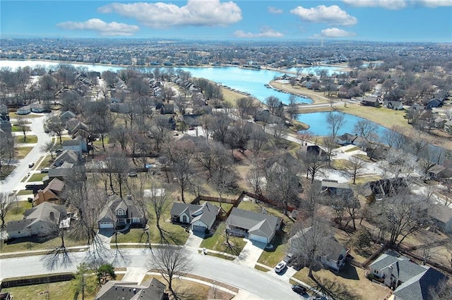 drone / aerial view featuring a residential view and a water view