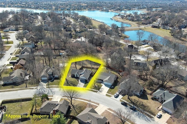 drone / aerial view with a water view and a residential view