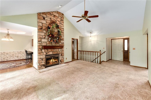 3824 SW Windemere Dr, Lees Summit, MO 64082 - unfurnished living room featuring ceiling fan, carpet floors, baseboards, high vaulted ceiling, and a stone fireplace