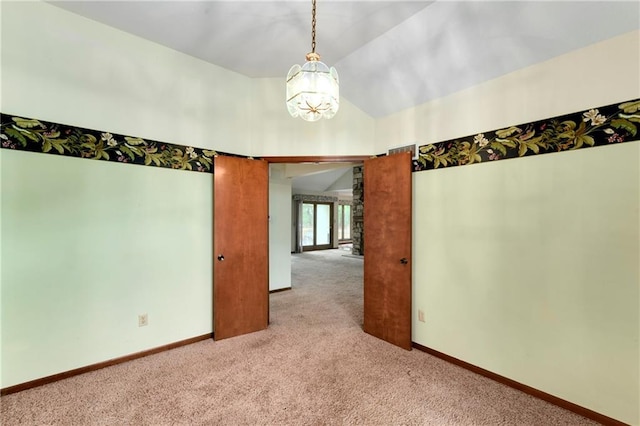 3824 SW Windemere Dr, Lees Summit, MO 64082 - carpeted empty room featuring vaulted ceiling, a chandelier, and baseboards