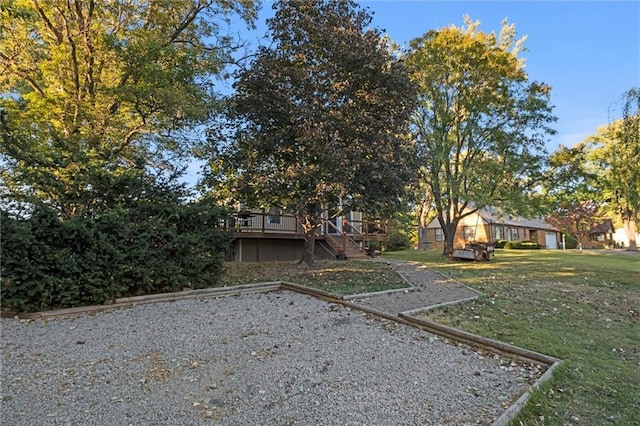 view of front of property with a deck, stairway, and a front yard