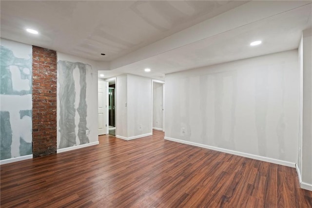 empty room featuring recessed lighting, baseboards, and wood finished floors