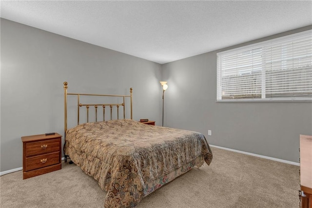 bedroom with light colored carpet, a textured ceiling, and baseboards