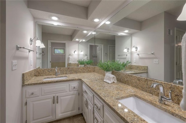 bathroom featuring double vanity, recessed lighting, a sink, and tile patterned flooring