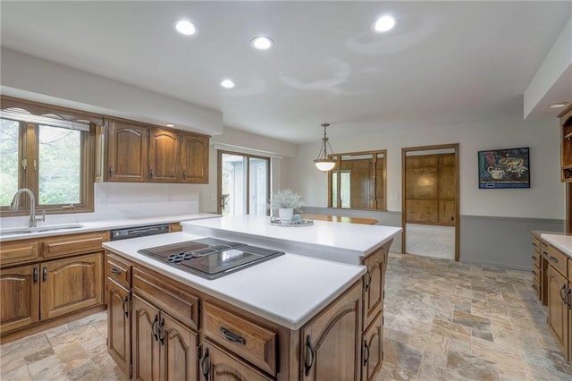 12016 Ballentine St, Overland Park, KS 66213 - kitchen with a sink, black electric cooktop, a center island, light countertops, and light stone finish flooring