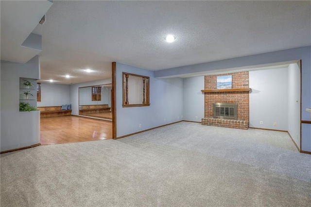 12016 Ballentine St, Overland Park, KS 66213 - unfurnished living room featuring carpet flooring, baseboards, a fireplace, recessed lighting, and a textured ceiling