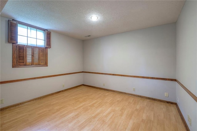 12016 Ballentine St, Overland Park, KS 66213 - unfurnished room featuring wood finished floors, a textured ceiling, baseboards, and recessed lighting