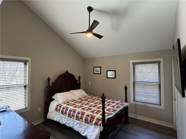 bedroom featuring dark wood-style floors, multiple windows, and lofted ceiling