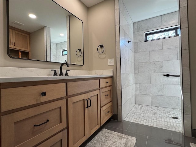 full bathroom featuring vanity, visible vents, tiled shower, recessed lighting, and tile patterned floors