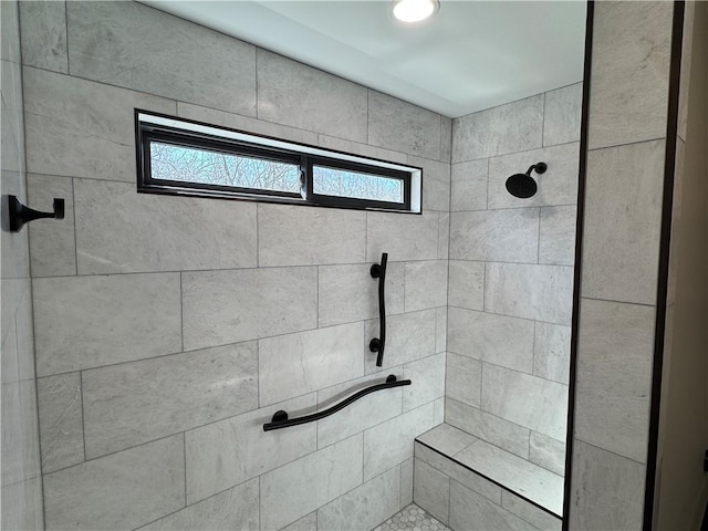 full bathroom featuring tiled shower