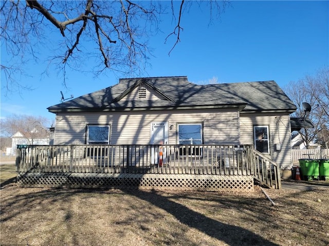 rear view of house with a wooden deck