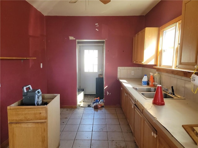 kitchen featuring light tile patterned floors, light countertops, ceiling fan, and a sink