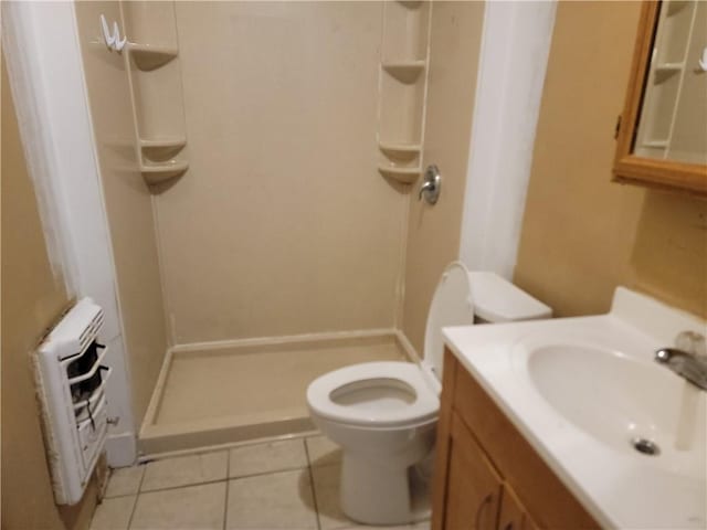 bathroom with heating unit, toilet, a shower stall, vanity, and tile patterned flooring