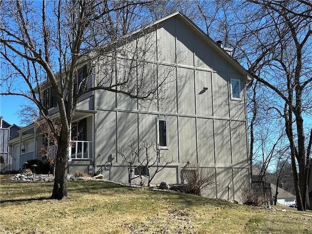 view of side of property with a lawn and a barn