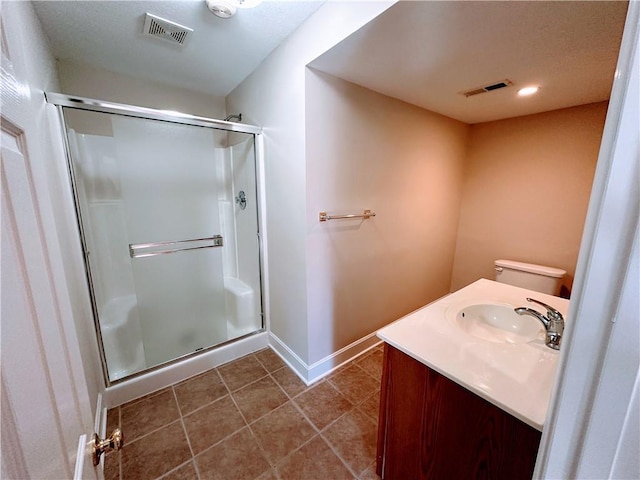 bathroom with a stall shower, visible vents, baseboards, toilet, and tile patterned flooring