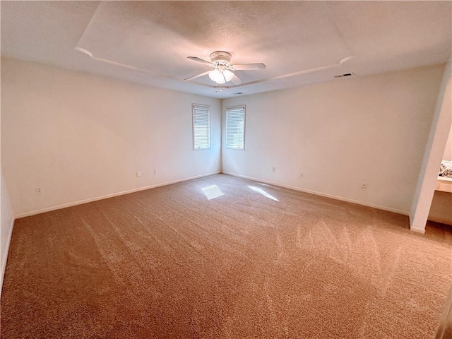 empty room featuring visible vents, baseboards, ceiling fan, a textured ceiling, and carpet flooring