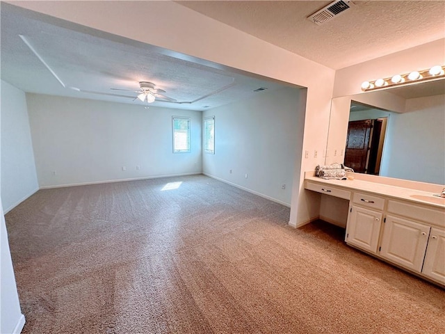 bathroom featuring baseboards, visible vents, a ceiling fan, a textured ceiling, and vanity